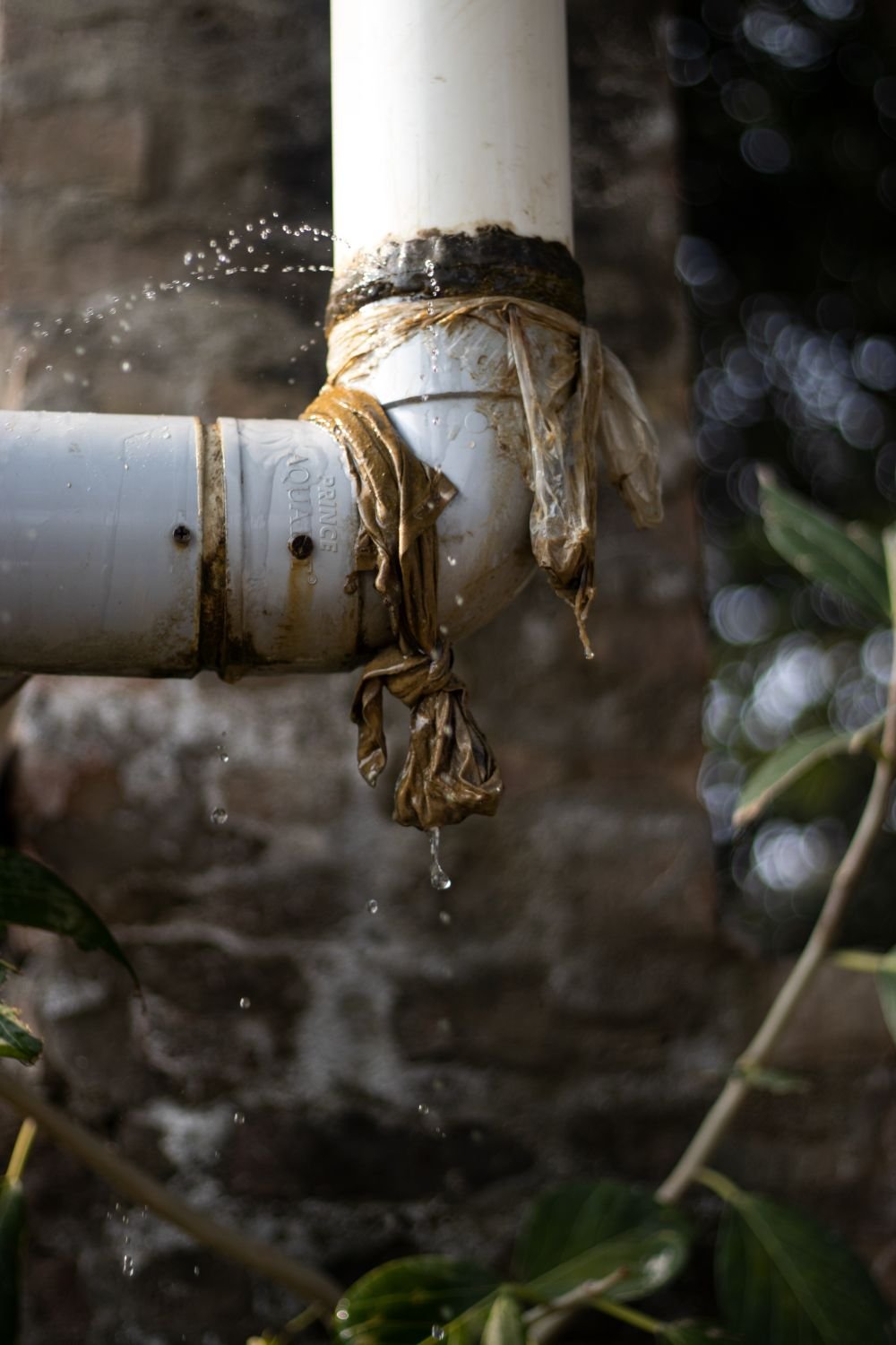 Plumber repairing burst water pipe