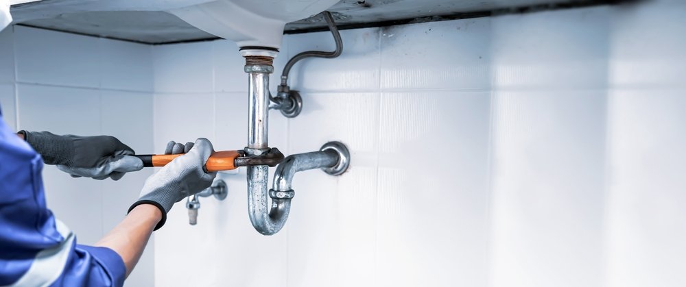 Plumber carrying out general maintenance work